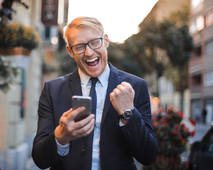 Man in Black Suit Jacket Received A Good News